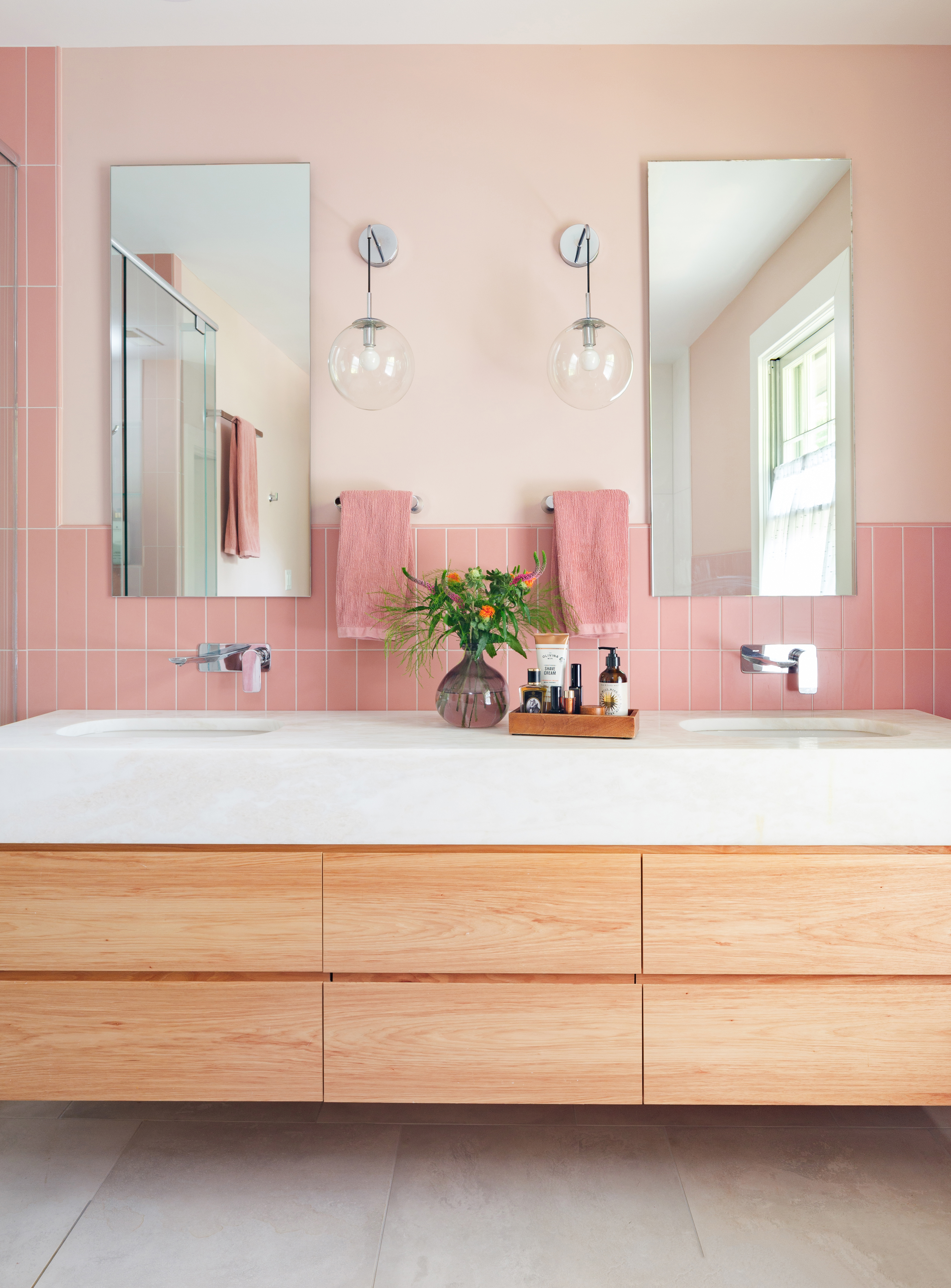 Bathroom with pink tile accents and double vanity in Webster Groves, Missouri — design build firms St. Louis