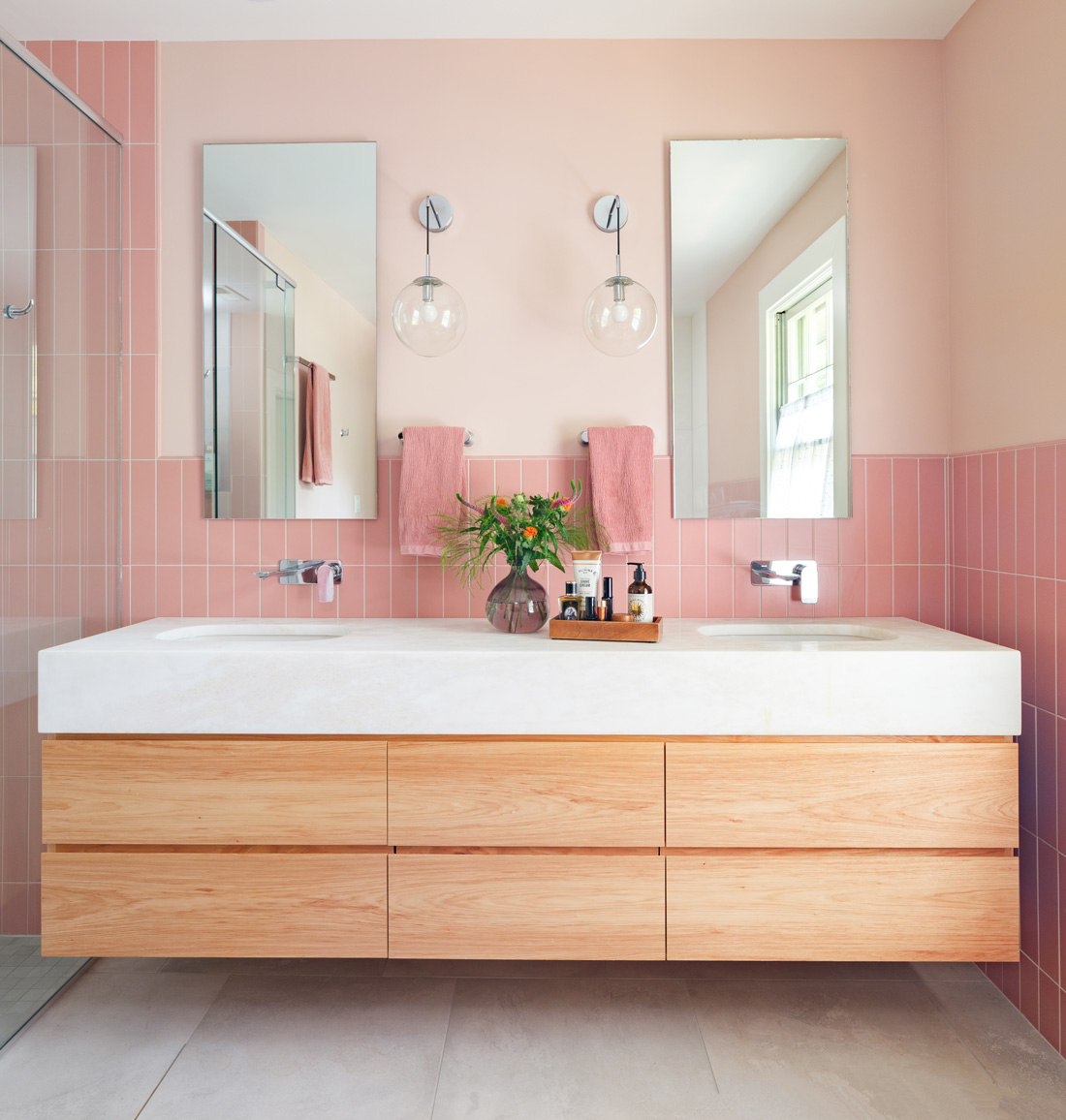 Bathroom with pink tile accents and double vanity in Webster Groves, Missouri — design build firms St. Louis