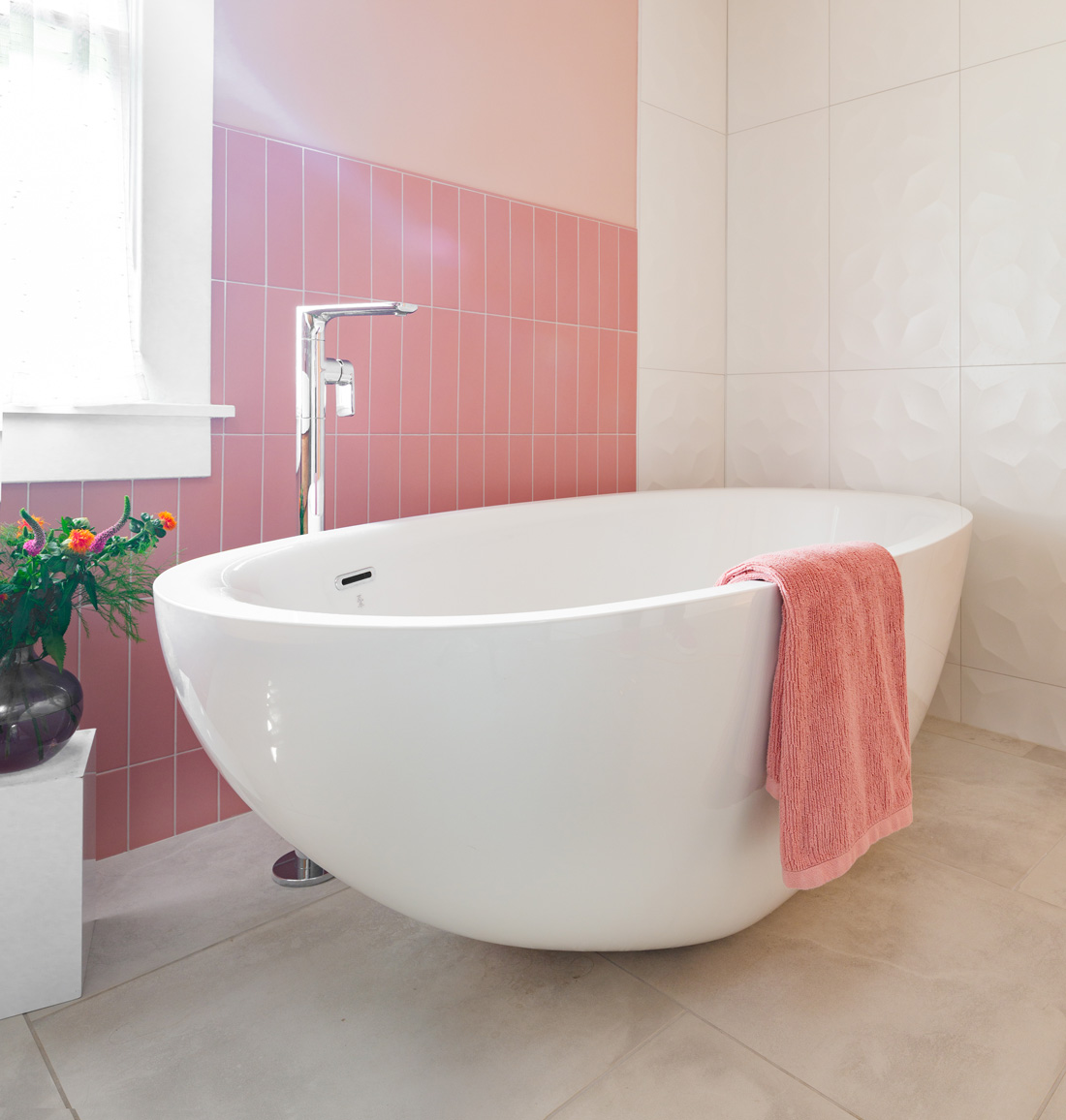 Freestanding bathtub with pink tile accent wall in Webster Groves, Missouri — design build home remodeling company St. Louis