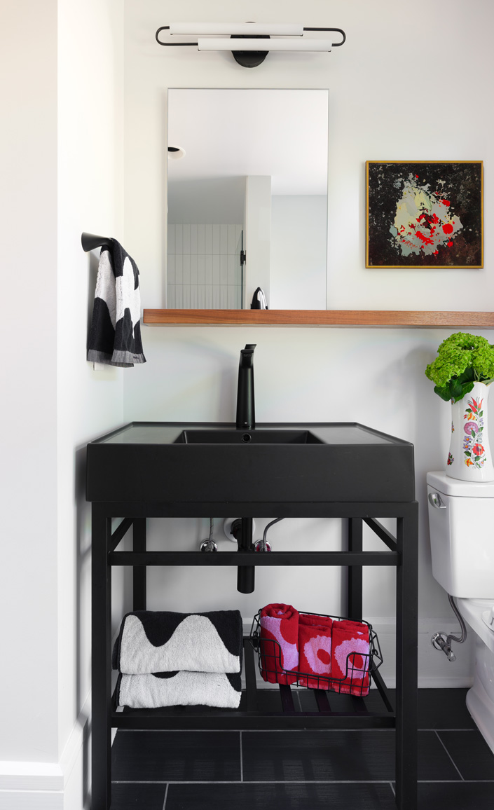 Bathroom with black open-frame vanity and patterned towels in Webster Groves, Missouri — design build St. Louis