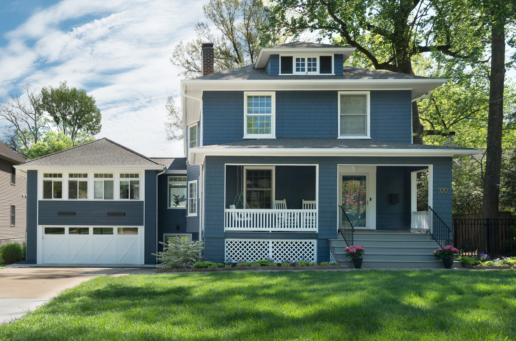 Exterior of blue Craftsman-style home with front porch in Webster Groves, Missouri — design build remodeling company St. Louis
