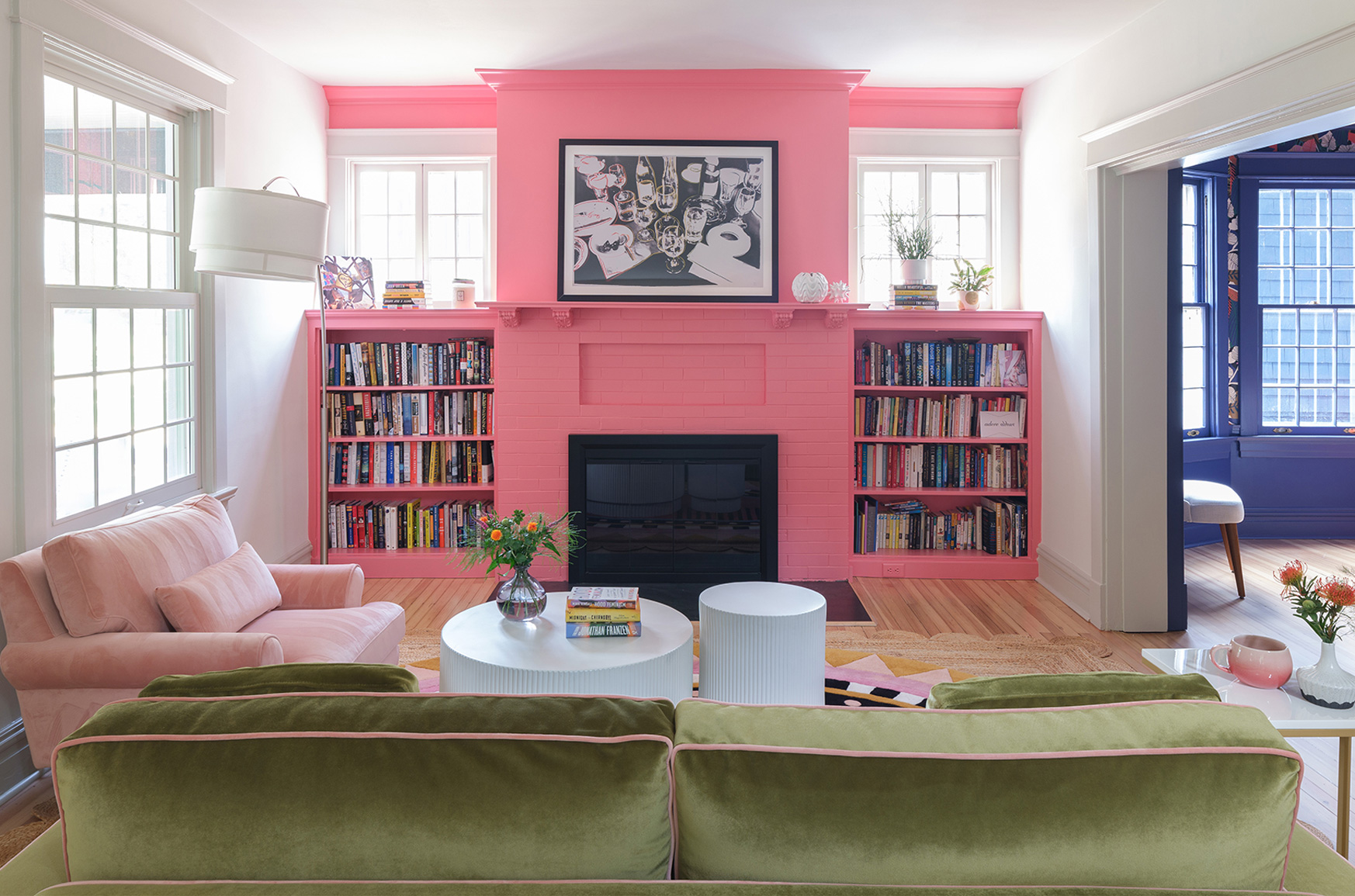 Living room with green velvet sofa and pink fireplace in Webster Groves, Missouri — design build St. Louis