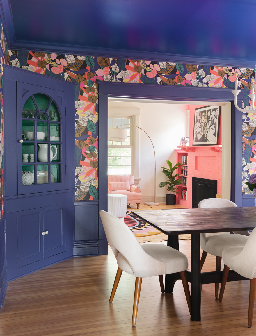 Dining room with bold floral wallpaper and modern white chairs in Webster Groves, Missouri — design build remodeling company St. Louis