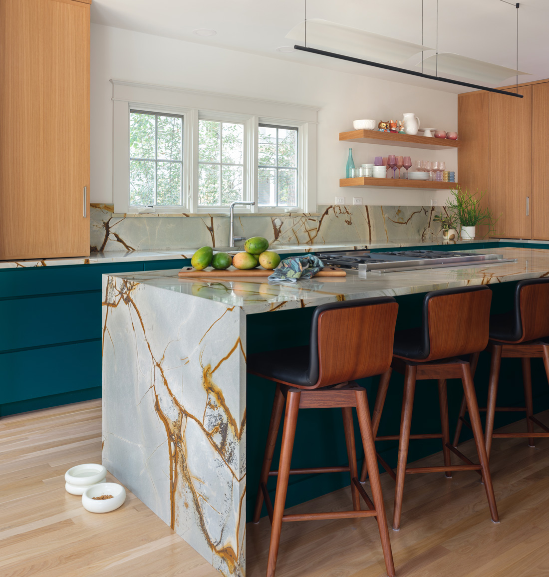 Contemporary kitchen with stainless appliances and teal cabinets in Webster Groves, Missouri — architect remodeling St. Louis