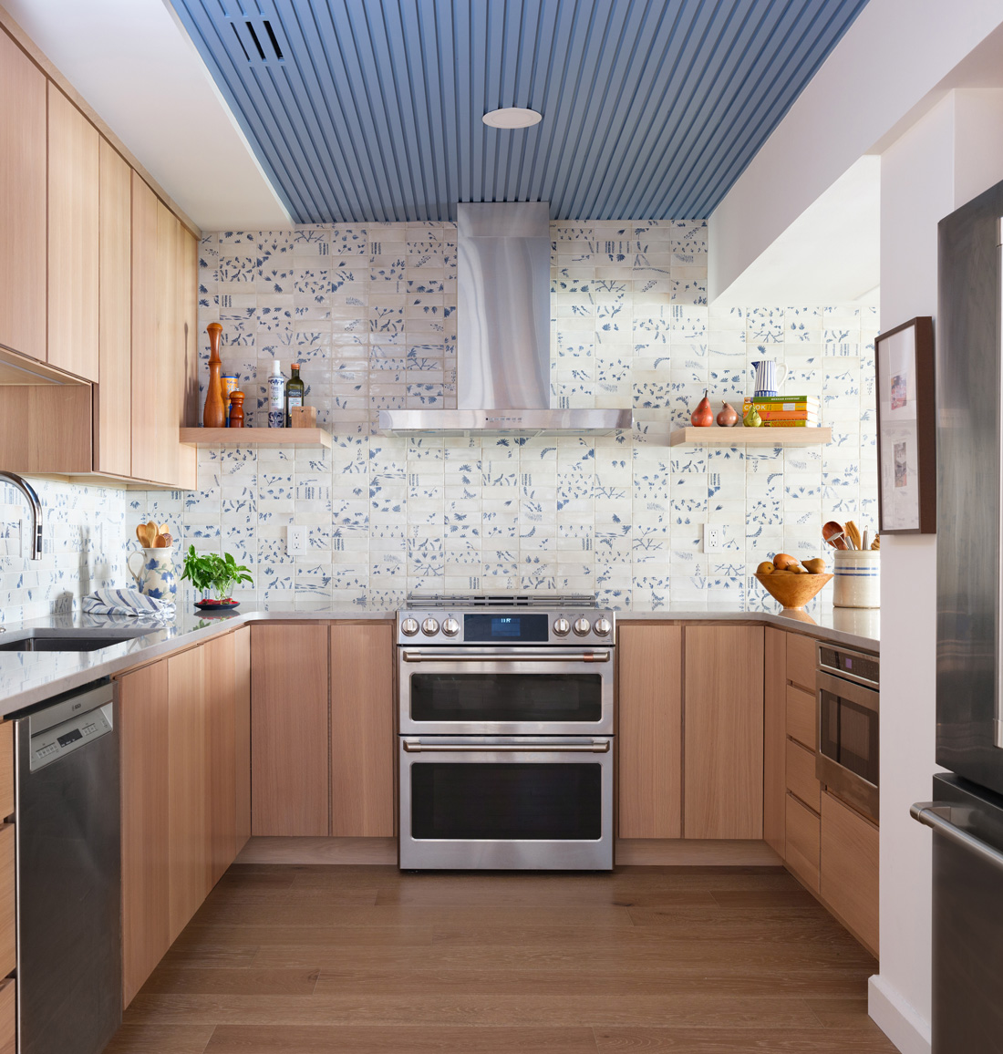 Kitchen with blue ceiling and patterned backsplash – U-shaped kitchen with custom cabinetry and blue paneled ceiling in a Central West End remodel by Hercules Design Build, a general contractor Hercules trusted for custom kitchen designs.
