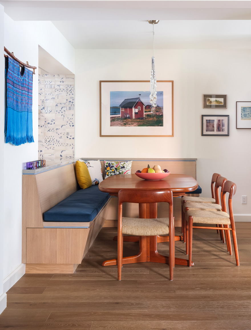 Dining nook with wall art – Built-in banquette dining nook featuring vibrant artwork in a Central West End home remodel by Hercules Design Build, among the top design build firms St. Louis homeowners choose.