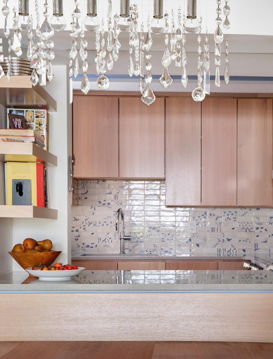 Kitchen detail with crystal chandelier – Elegant kitchen detail with crystal chandelier and custom backsplash in a Central West End remodel by Hercules Design Build, a design build St. Louis leader.